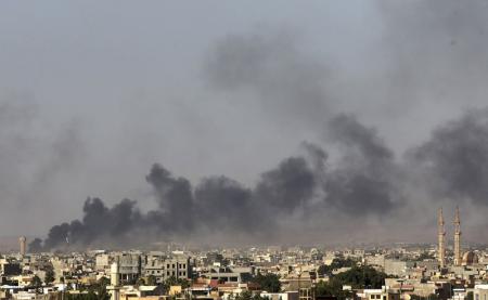 Black plumes of smoke is seen in the vicinity of Camp Thunderbolt, after clashes between militants, former rebel fighters and government forces in Benghazi July 26, 2014. REUTERS/Esam Omran Al-Fetori