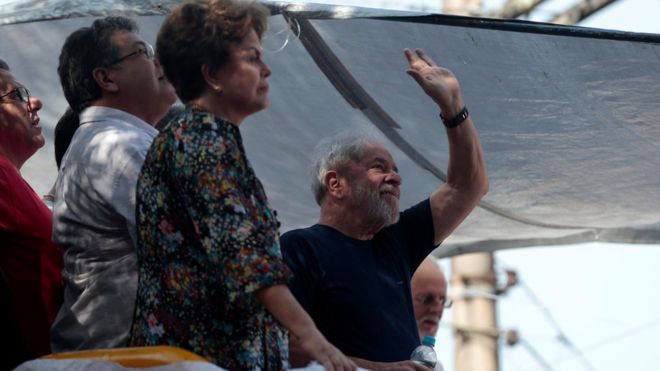 Dilma Rousseff (foreground) was at the side of Lula, seen here waving