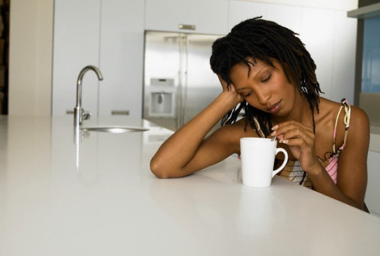 Bored Young Woman Stirring Coffee --- Image by © Vincent Mo/zefa/Corbis