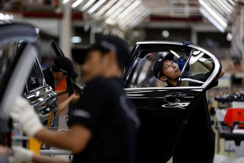Workers put together doors for a locally assembled new BMW 7 Series on the production line at a Gaya Motor assembly plant in Jakarta, Indonesia November 30, 2016.   REUTERS/Darren Whiteside