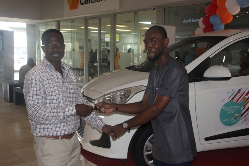 West Hills Centre Manager, Mr. Jacob Quarmson, presents keys to one of the two i10 Hyundai cars to the brother of the winner, Mr. Benjamin Yawson