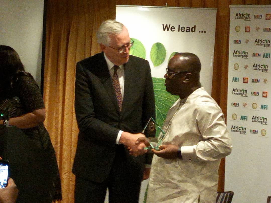 Sir John receiving the award from the CEO of the African Leadership Magazine, Dr. Ken Giami.