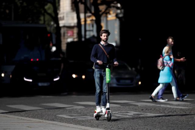 Lime’s France director Arthur-Louis Jacquier rides a dock-free electric scooter Lime-S by California-based bicycle sharing service Lime on their launch day in Paris, France, June 22, 2018. REUTERS/Benoit Tessier