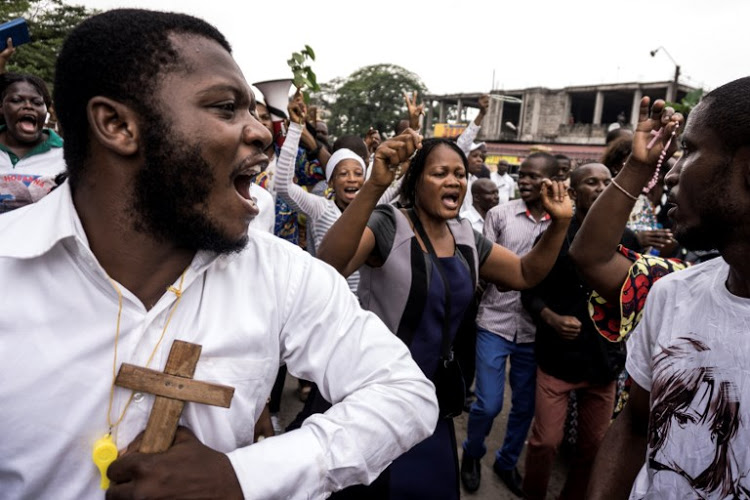 Congolese Catholic faithfuls sing and dance during a demonstration to call for the President of DR Congo to step down, in Kinshasa.  (Source: AFP)
