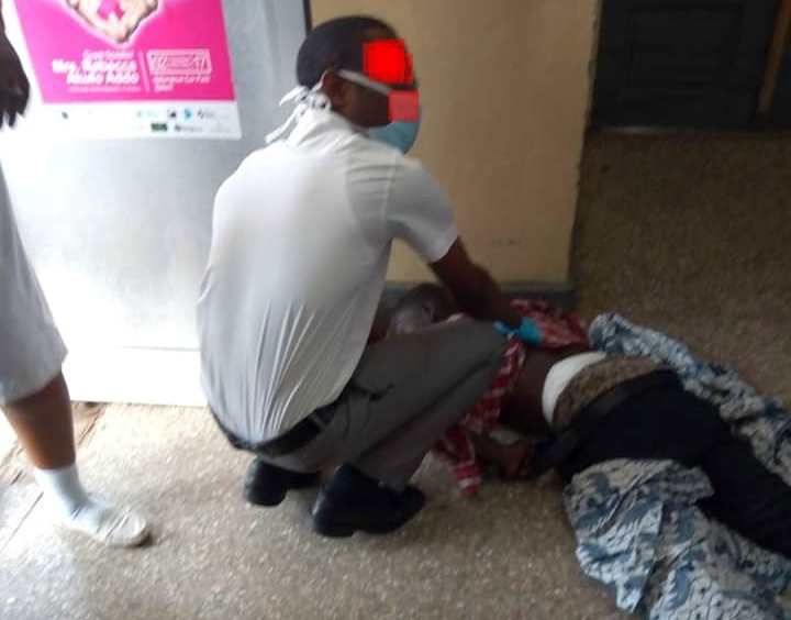 A patient at the Korle Bu hospital receives medical attention on the floor