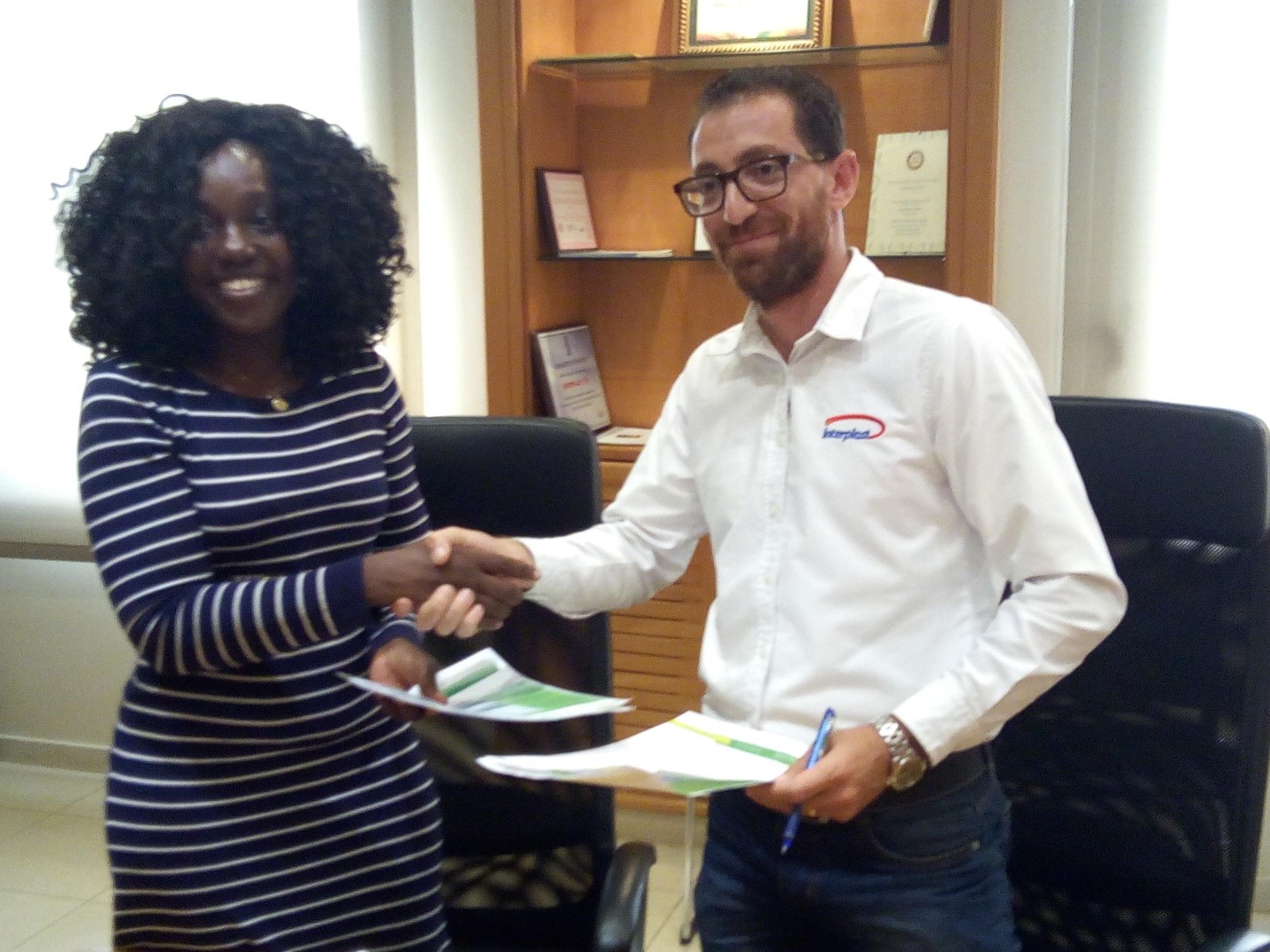 Alberta Nana Akyea Akosa of Agrihouse Foundation receiving the support documents from Mr Haidar Malhas of Interplast Limited