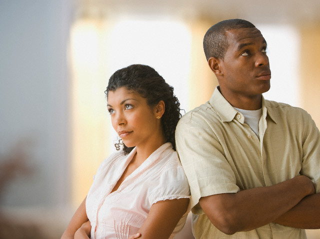 West New York, New Jersey, USA --- Angry African American couple standing back to back --- Image by © Jose Luis Pelaez, Inc./Blend Images/Corbis