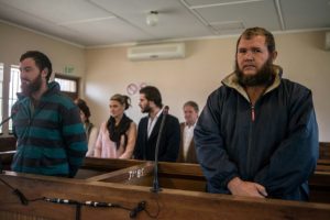 South African court finds white farmers guilty of murdering black teen
