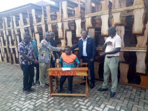 Asante Akyem North DCE presents furniture to schools