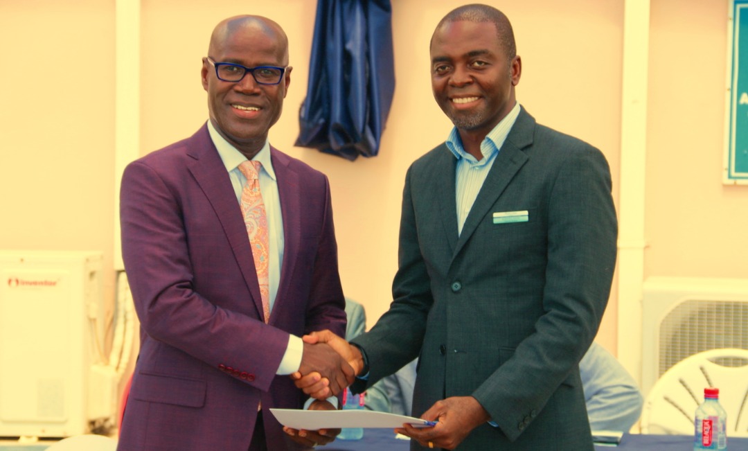 Country Director for PharmAccess Ghana, Dr. Maxwell Akwasi Antwi presenting the certification to Dr. Kojo Benjamin Taylor, Executive President of Sanford World Clinics.