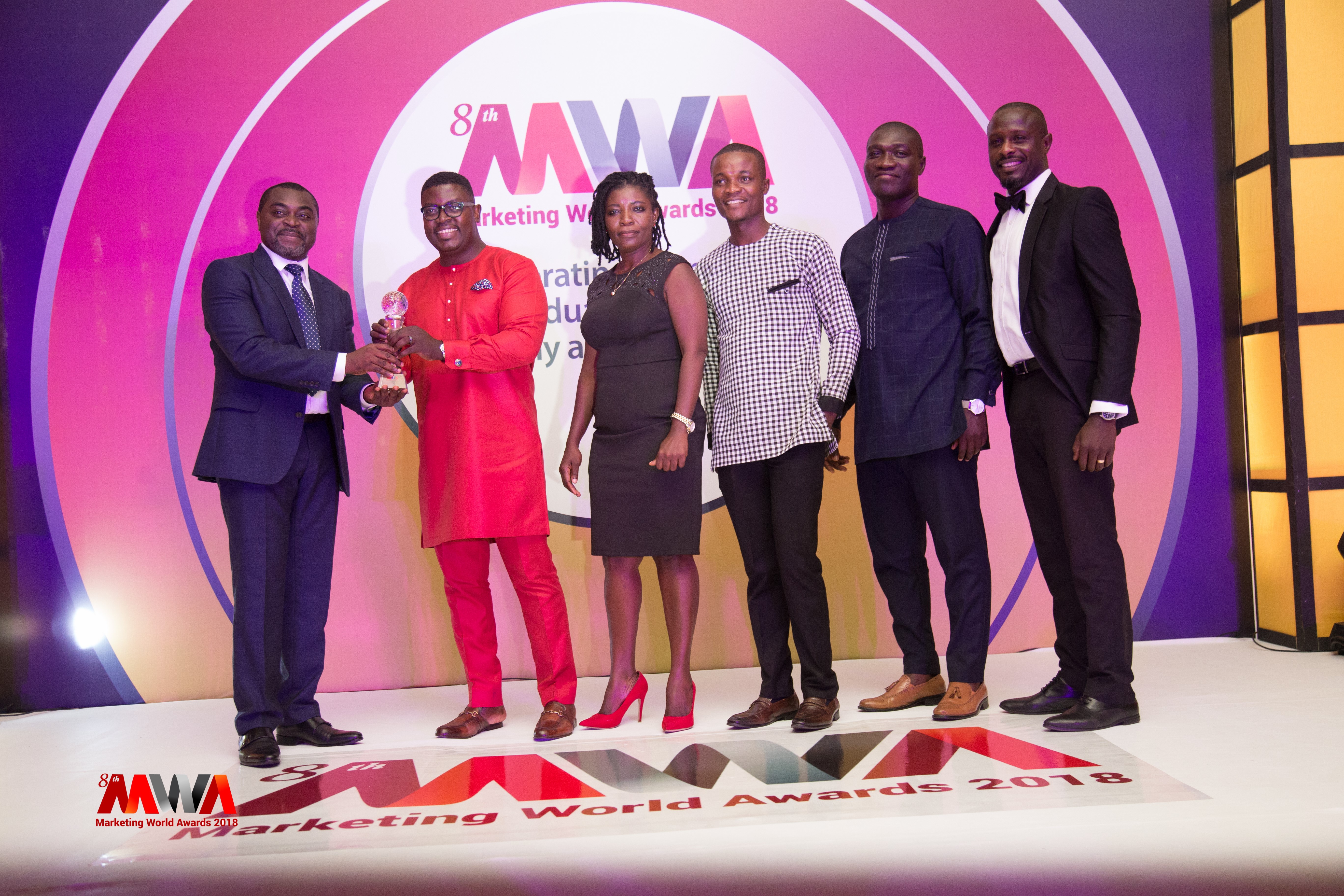 Akin Naphtal (L),CEO of InstinctWave, giving award to Andrew Ackah (R), CEO of Dentsu Aegis Network Ghana.