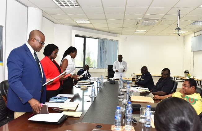 Ken Ofori-Atta, Minister of Finance (head of table) administering the Oath of Office to the new Board members (l to r ) Mr Ernest Akore, Mrs. Elsie Addo Awadzi & Ms. Afua Asaabea Asare