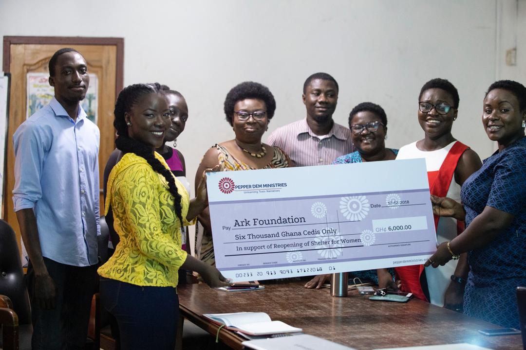 The Pepper Dem team presenting the dummy cheque to the Executive Director of the Ark Foundation, Dr. Angela Dwamena Aboagye.