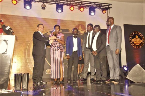Dr Lamisi Mbillah (2nd left), Customer Relations Manager at G4S, receiving the Security Company of the Year trophy on behalf of her company at the Ghana Business Awards. Behind her are other G4S officials.