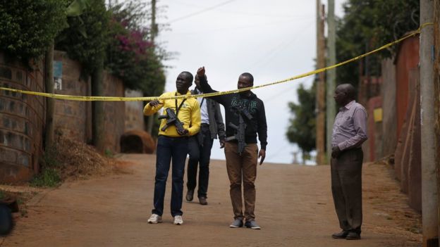 Police stand guard outside the home of one of the suspected attackers, in Kiambu County