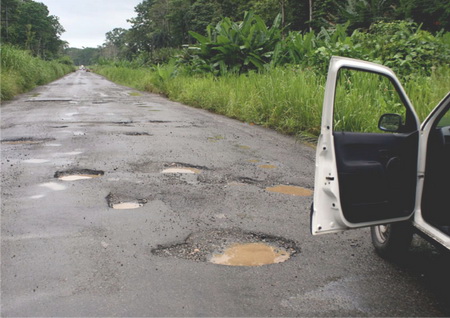 A pothole ridden road