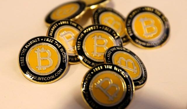 Bitcoin.com buttons are seen displayed on the floor of the Consensus 2018 blockchain technology conference in New York City, New York, U.S., May 16, 2018. REUTERS/Mike Segar