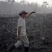A Brazilian farmer walks through a burnt area of the Amazon in Rondonia state