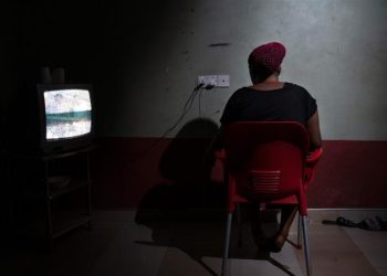 Blessing, a 26-year-old from Nigeria, inside the guesthouse where she lives with other 20 women who were also forced into prostitution [Francesco Bellina/Al Jazeera]