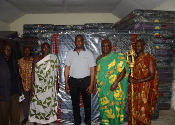 Mr. Jonathan Quaynor (3rd right) poses with Osabarima Adusei Peasah IV, Tafohene and some members of the Traditional Council after the presentation.