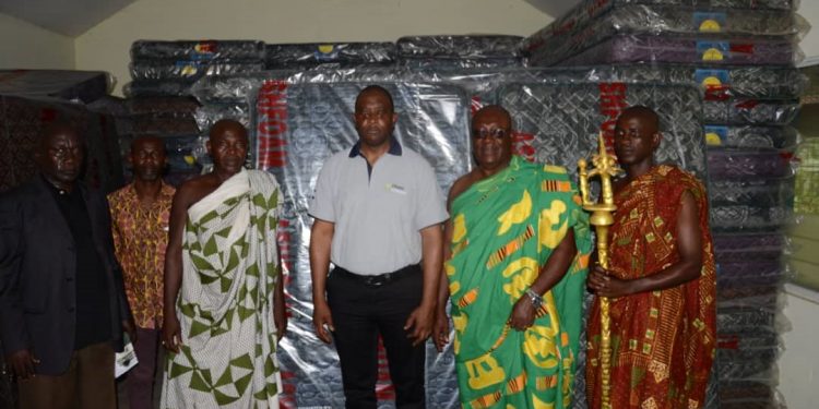 Mr. Jonathan Quaynor (3rd right) poses with Osabarima Adusei Peasah IV, Tafohene and some members of the Traditional Council after the presentation.