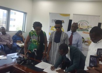 CEO of GEPA, Akua Asabea Asare and others look on as the two artistes to sign the deal.