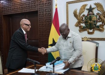 President Akufo-Addo receiving the report from Justice Emile Short