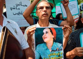 A demonstrator holds up a sign showing the portrait of Hajar Raissouni, a Morrocan journalist of the daily newspaper Akhbar El-Youm, with a caption below in Arabic and English reading "Akhbar El-Youm: no to the abortion of the free press", during a protest outside a courthouse holding her trial on charges of abortion in the capital Rabat on September 9, 2019. (Photo by FADEL SENNA / AFP)        (Photo credit should read FADEL SENNA/AFP/Getty Images)
