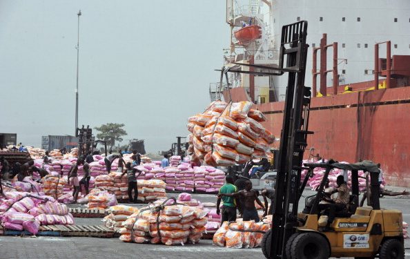Workers unload bags of rice on January 19, 2011 at the Port of Abidjan where 80% of Ivory Coast's exports transit. EU-registered ships have been barred from dealing with Ivory Coast's main cocoa ports in line with sanctions over the nation's controversial November presidential poll. The European Union last weekend slapped sanctions on outcast incumbent leader Laurent Gbagbo and 84 of his associates, as well as 11 economic entities in the world's top cocoa producer. AFP PHOTO/ ISSOUF SANOGO (Photo credit should read ISSOUF SANOGO/AFP/Getty Images)