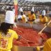 The sixteen-man Tasty Tom Jollof Mix Team of cooks at work to deliver Ghana's biggest ever pot of Jollof rice.