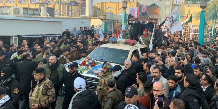 Media captionMourners surround a car carrying the coffin of Qasem Soleimani in Baghdad