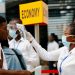 FILE PHOTO: A health worker checks the temperature of a traveller as part of the coronavirus screening procedure at the Kotoka International Airport in Accra, Ghana January 30, 2020. REUTERS/Francis Kokoroko/File Photo - RC2EUE9X5YKK