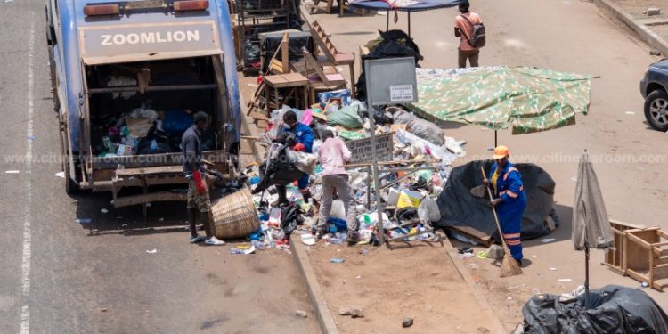 A Zoomlion truck being loaded with rubbish at Madina during the lockdown of Accra