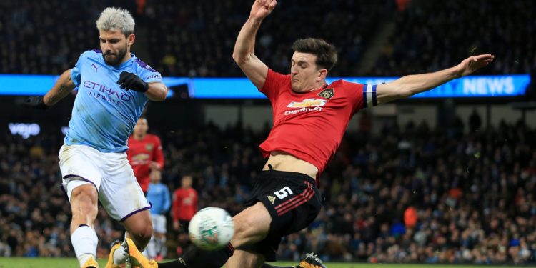 MANCHESTER, ENGLAND - JANUARY 29: Harry Maguire of Man Utd tries to block a shot from Sergio Aguero of Man City during the Carabao Cup Semi Final match between Manchester City and Manchester United at the Etihad Stadium on January 29, 2020 in Manchester, England. (Photo by Simon Stacpoole/Offside/Offside via Getty Images)