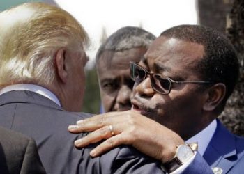 Akinwumi Adesina, President of the African Development Bank, hugs U.S. President Donald Trump after a family photo of G7 leaders and Outreach partners, in the Sicilian town of Taormina, Italy, Saturday, May 27, 2017. (AP Photo/Andrew Medichini)
