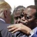 Akinwumi Adesina, President of the African Development Bank, hugs U.S. President Donald Trump after a family photo of G7 leaders and Outreach partners, in the Sicilian town of Taormina, Italy, Saturday, May 27, 2017. (AP Photo/Andrew Medichini)