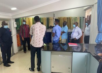 Mr. Kofi Sekyere,(second from left) briefs journalists about the range of products supplied by the company as Mr. Isaac Kyei-Mensah (extreme left) looks on.
