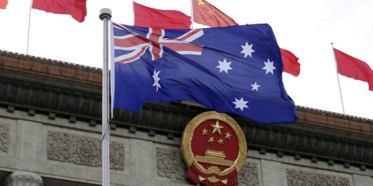 FILE PHOTO: An Australian flag flutters in front of the Great Hall of the People during a ceremony in Beijing, China, April 14, 2016. REUTERS/Jason Lee