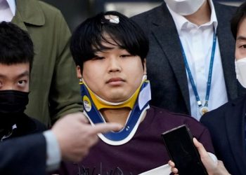 Cho Ju-bin photographed outside the police station earlier this year, wearing a neck brace