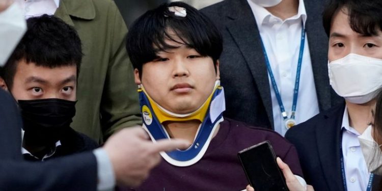Cho Ju-bin photographed outside the police station earlier this year, wearing a neck brace
