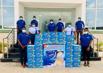 Staff of Nutrifoods Ghana pose with samples of Perk Milkrich Biscuits
