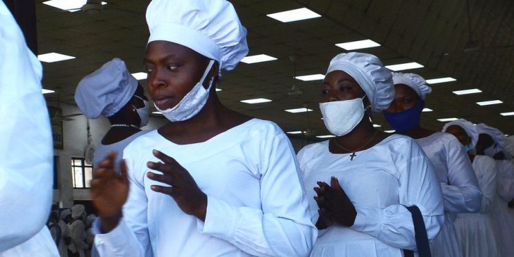Members of the Celestial Church of Christ wear a one-piece white garment made from flammable fabric