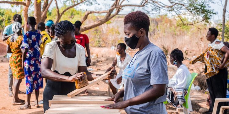 Beneficiaries being trained on building honeybee trap box in Senya Beraku