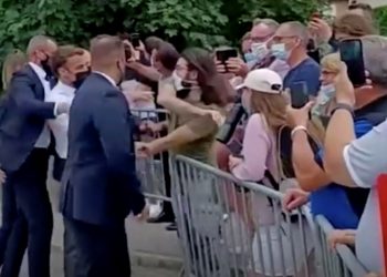 French President Emmanuel Macron gets slapped by a member of the public during a visit in Tain-L'Hermitage, France, in this still image taken from video on June 8, 2021. BFMTV/ReutersTV via REUTERS ATTENTION EDITORS - THIS VIDEO WAS PROVIDED BY A THIRD PARTY. THIS IMAGE WAS PROCESSED BY REUTERS TO ENHANCE QUALITY. UNPROCESSED VERSION OF THE VIDEO WAS PROVIDED SEPARATELY. NO RESALES. NO ARCHIVE. FRANCE OUT. NO COMMERCIAL OR EDITORIAL SALES IN FRANCE