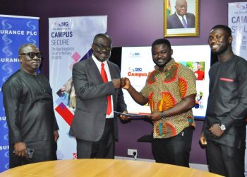 Mr. Stephen Oduro (2nd left) exchanges document with leadership of NUGS led by the President, Emmanuel Boakye Yiadom