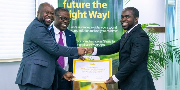 (L-R) Nii Amankra Tetteh, UMB Executive Director, Business with Philemon Okyere Danquah, GM, Corporate Banking, presenting an  award to Kwadwo Aduameyaw Mante