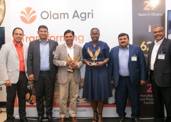 Officials of Olam Agri pose with Amit Agrawal as Christiana Anim Asare, the company’s Business Manager for Local Rice, helps out with the trophies.