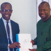 Dr. Antwi-Boasiako, Director General of the Cyber Security Authority presenting a copy of the guideline to Mr. John Awuah, President of the Ghana Association of Banks