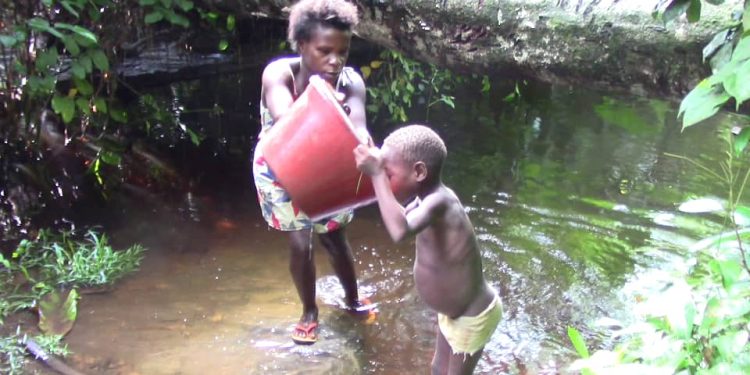 Pygmy family drinks from a swamp in Keinke, Cameroon, 2023. Picture Credit: Robert Abunaw