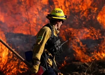 A firefighter works to extinguish the Highland Fire, a wildfire near Aguanga, California, October 31, 2023